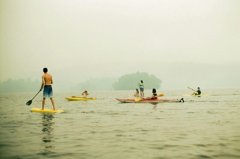 Summer adventure photoshoot with kayaking and jet skiing on open water