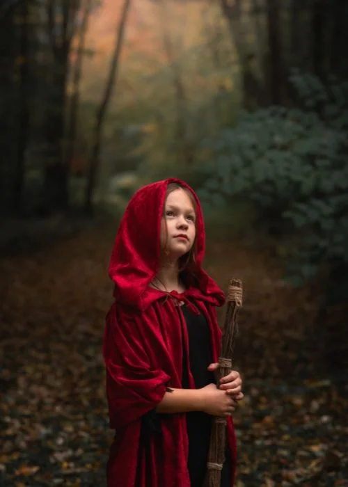 magical photo of a little girl in red hood by a creative portrait photographer