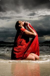 Women in red red dress on a beach