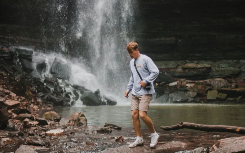senior photography near a cascading waterfall