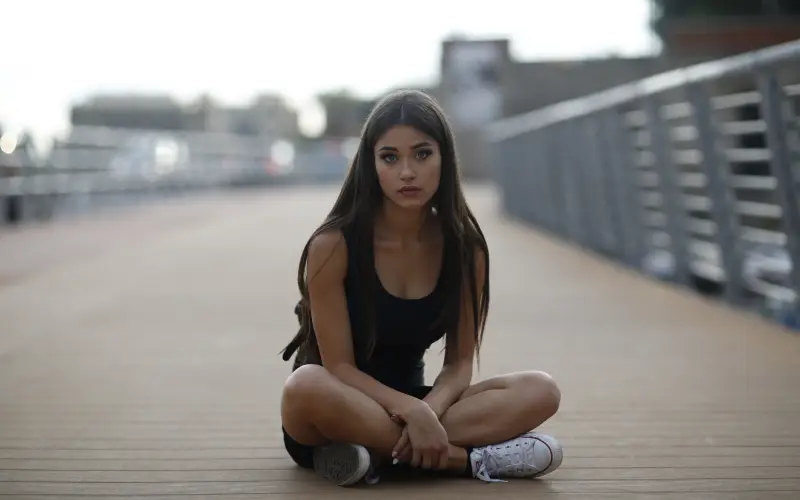 photo of a girl sitting outdoors
